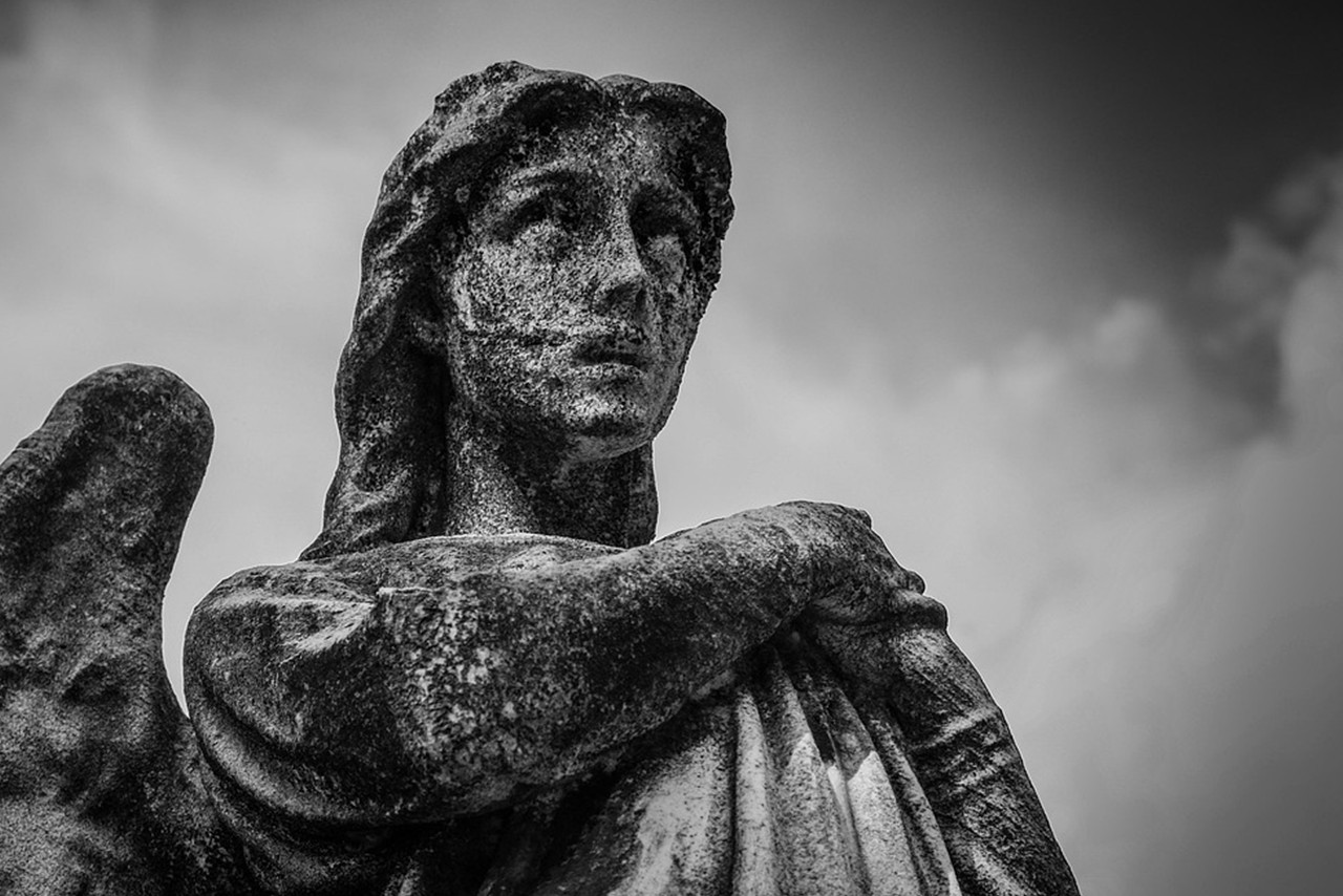 Female angel statue from the shoulders up.