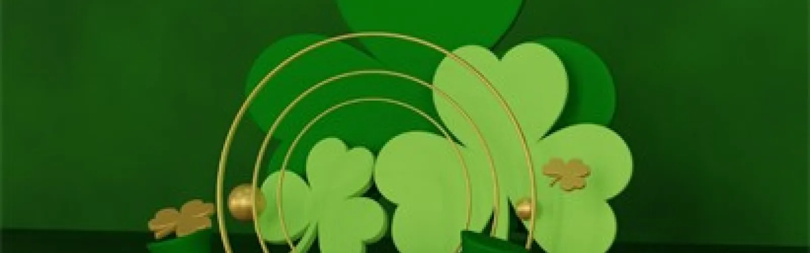 Pot of gold in front of shamrocks.