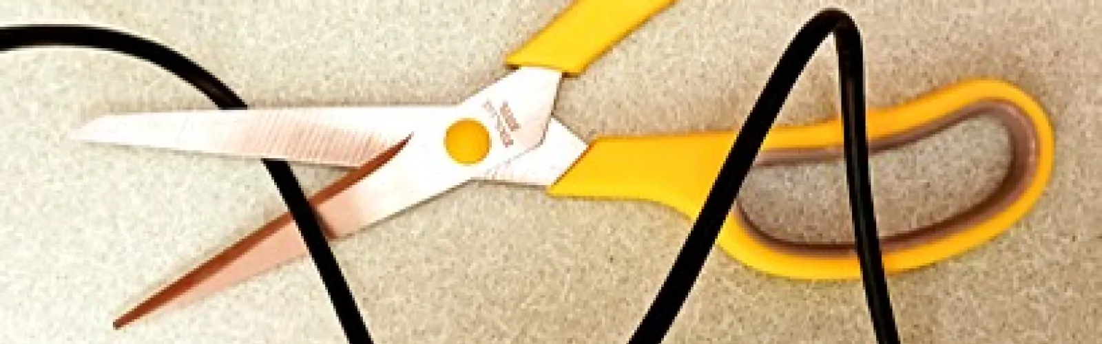 Scissors poised to cut a cord.